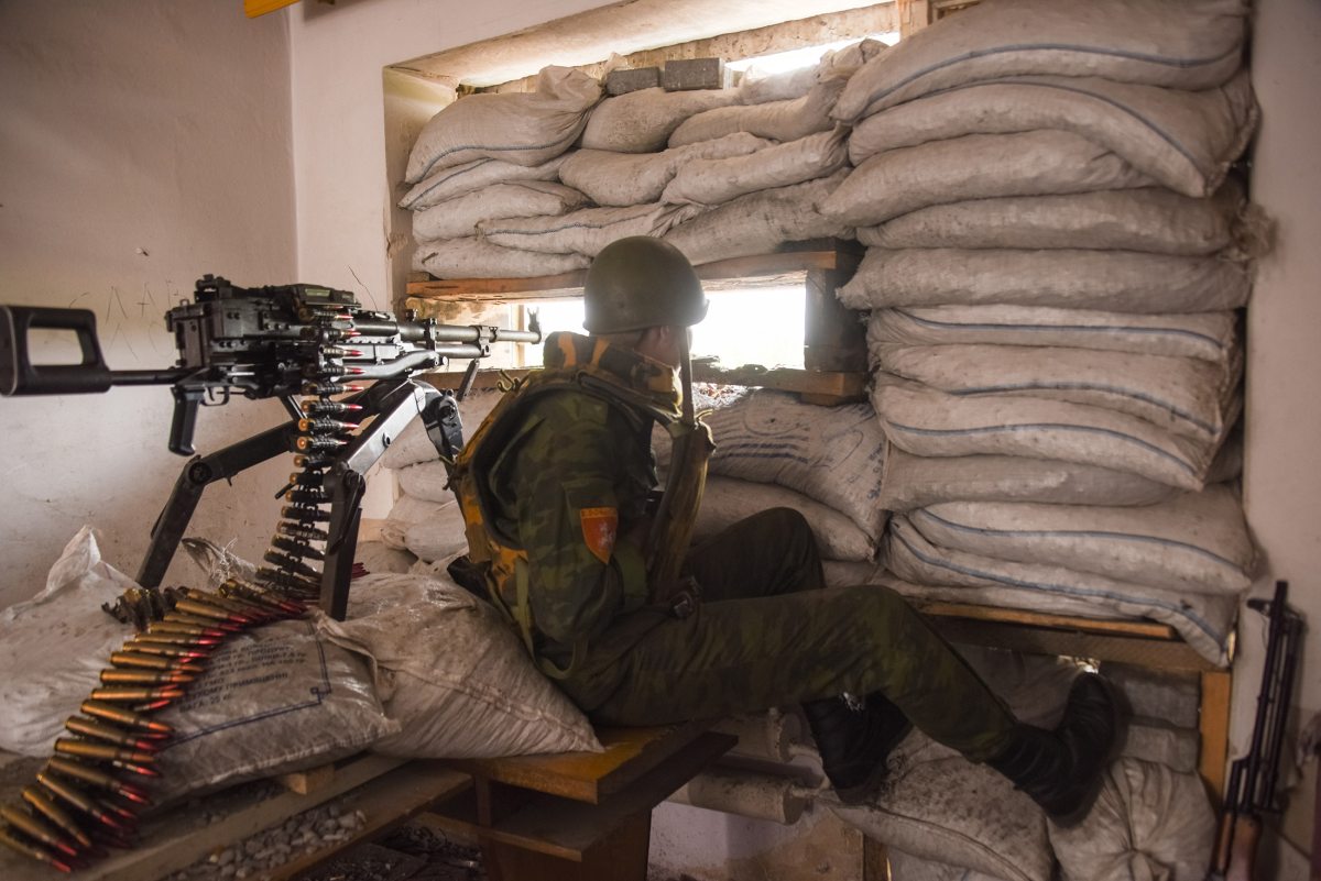 a_russia_backed_rebel_looking_though_firing_port_at_his_position_near_donetsk_eastern_ukraine_may_26_2015.jpg